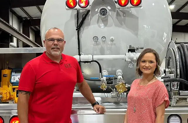 Man and Woman Smiling in Front of Truck