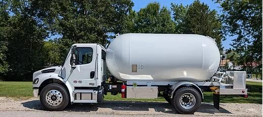 Side View of a White Truck With a Large Cylindrical Tank