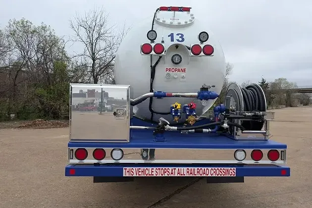 White and Blue Service Truck With Hose Attached White and Blue Service Truck With Hose Attached